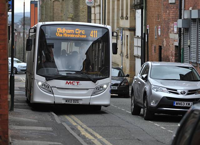 NO room for manoeuvre . . . a bus mounts the curb to squeeze past