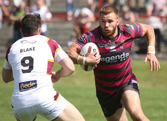 SEEKING A WAY THROUGH . . . Tom Spencer, of Oldham, runs hard at the Batley Bulldogs line