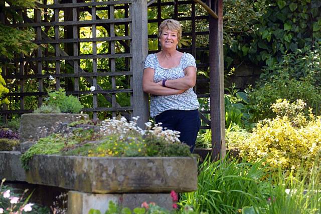 HELEN Barnes relaxes in her garden