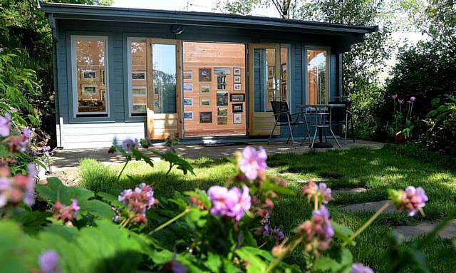 Pictured here is Helen Campbell and her garden at Crib Lane, Dobcross, where she has opened an art gallery to show her work and that of local artists.
