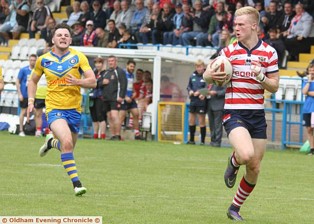 UP AND RUNNING . . . Kieran Gill races in to score Oldham's first try      