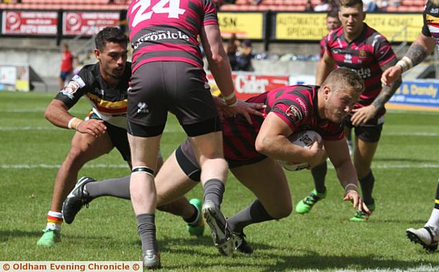 TRY TIME . . . Oldham's Jack Blagbrough crashes across the line  