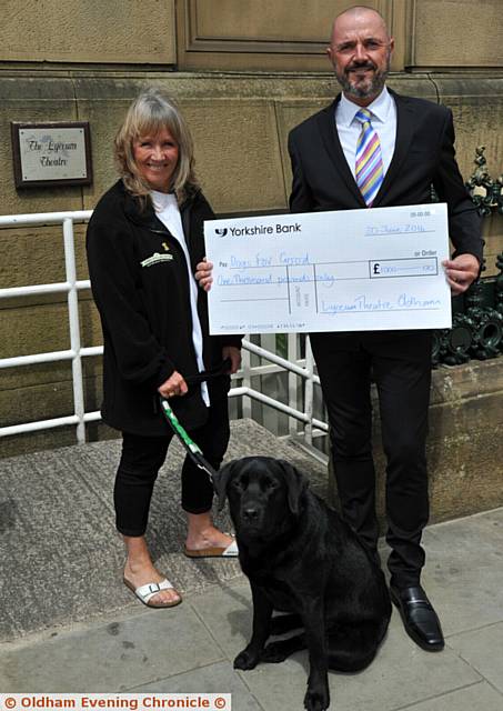 Cathy Dore (Dogs for Good) and Mark Higginbottom (Chairman of Lyceum Theatre) and Zeb the dog, a puppy in training.
