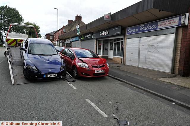 RTA on Trough Gate, Hollins. Blue car shunted red car into a man who was unloading from his silver Volvo to his takeaway 'Ocean Palace'.