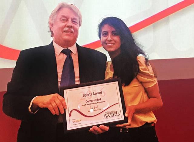 HEAD Kevin Sartain receives a certificate from Konnie Huq