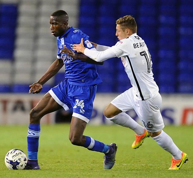 ON THE BURST . . . Ousmane Fane makes a break for Latics