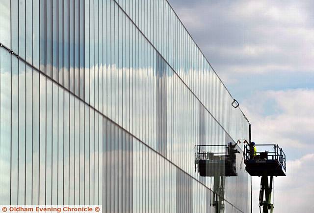 Men working on the glass at the new Town Hall redevelopment in Oldham.