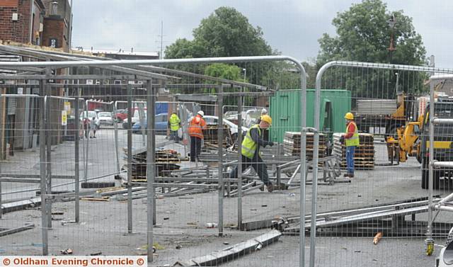 PACKING up . . . workmen clear the former Shaw market site