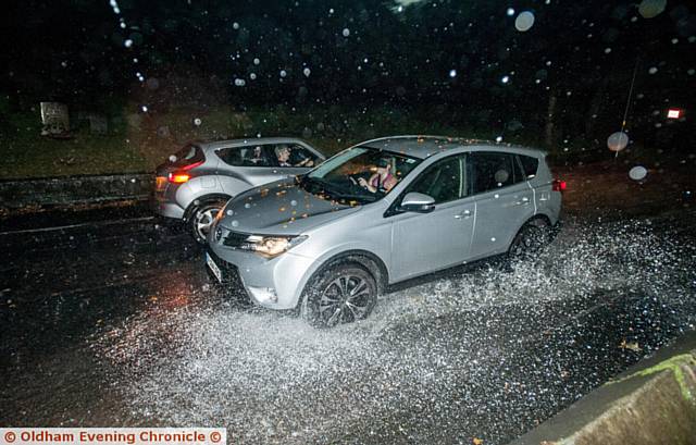 CAUGHT in the deluge . . . car on Oaklands Road in Friezland