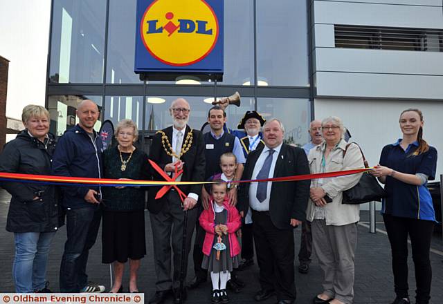 THE Mayor and Mayoress of Oldham, Cllr Derek Heffernan and Di Heffernan, perform the official opening with first customer in the queue, Paul Bamforth, and other guests
