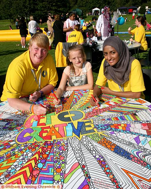 Mahdlo volunteer, Sue Hoyle, Kacie Bolton, aged 8, Rebekah Begum, Mahdlo membership marketing officer, undertaking a creative colouring exercise