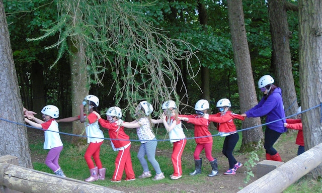 Working as a team, Rainbows support each other on a blindfolded trail