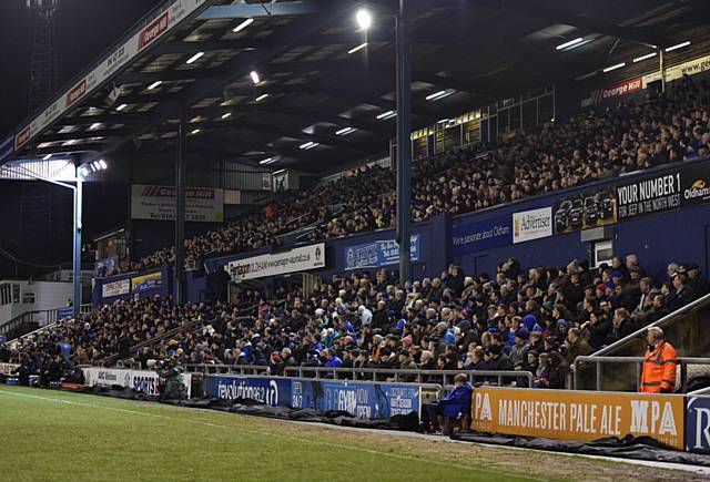 MAIN STAND supporters soak up the atmosphere at Oldham Athletic