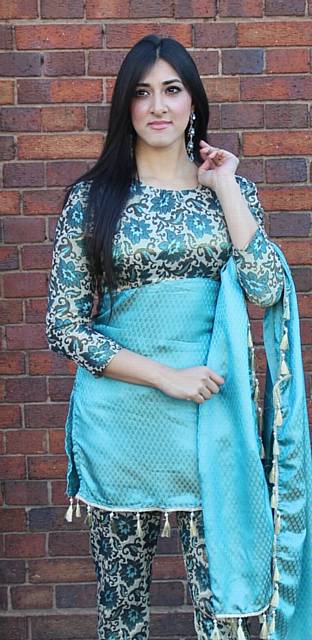 Alia models a traditional Pakistani-style outfit made of brocade with a tassle trim across the hemline and the scarf.
