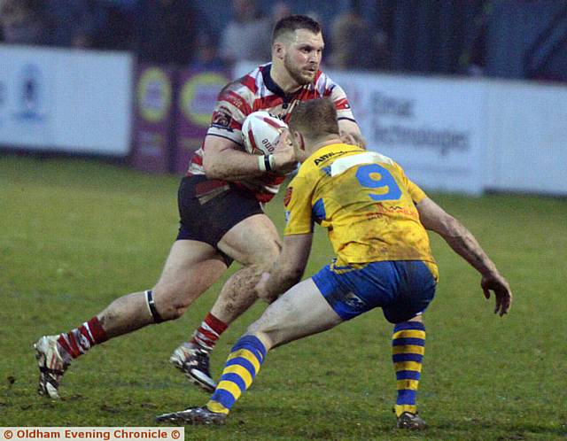 GOOD TO BE BACK: Oldham's Steven Nield, returning after a long injury lay-off, probes the Swinton line