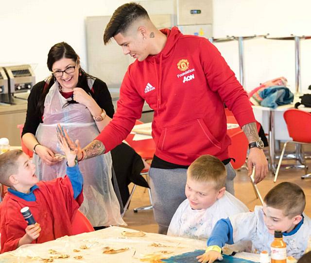 Marcus Rojo with pupils, from left, Alfie Smith, Martin Kleinschmidt and Leo Smith, and assistant head teacher Jenni Cryer