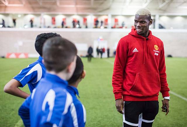 SUPERSTAR Paul Pogba with Waterhead Academy pupils
