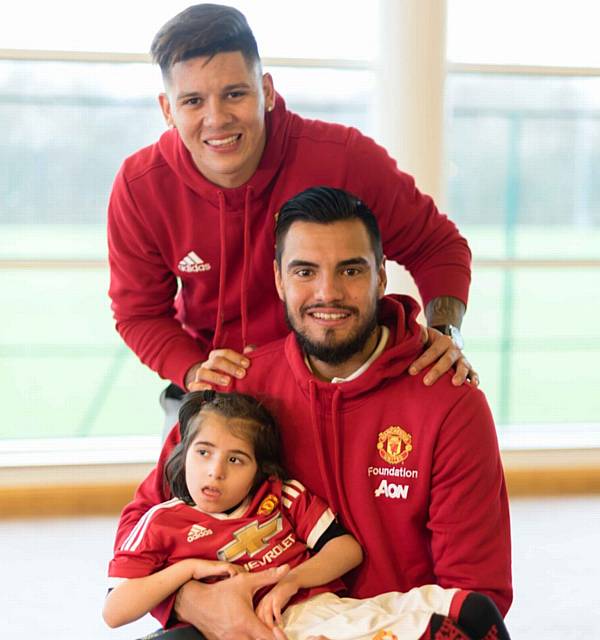 UNITED stars Marcus Rojo (back) and Sergio Romero with Laiba Ali