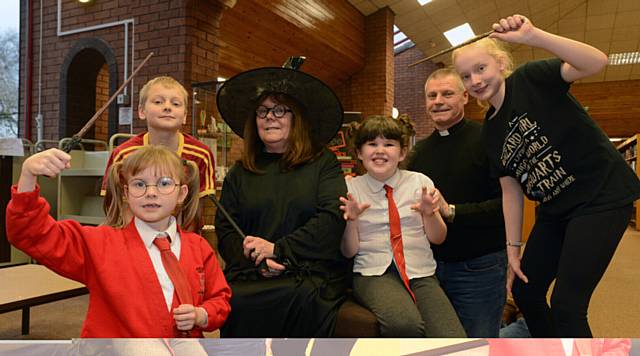 SPELLBOUND . . . from left, Ellie Walker, Jacob Clarke, Susan Wright-Westland (library assistant), Maisie-Leigh Read, Rev David Woodall (St. James's), Megan Clarke at Crompton Library