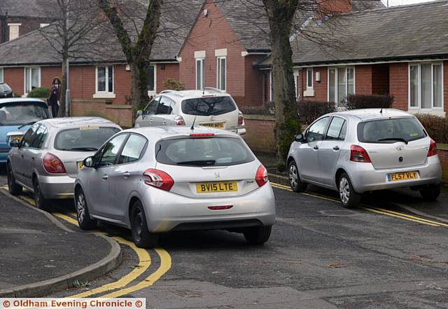 WAITING . . . Cars on yellow lines and the pavement on Lynmouth Avenue, Hathershaw