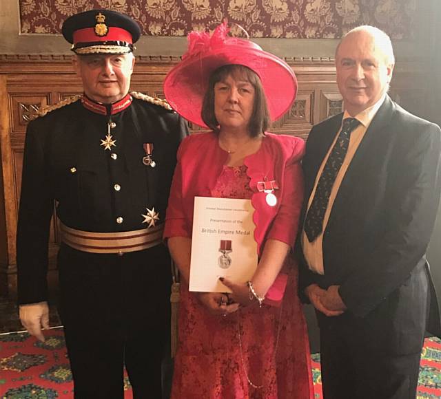 HONOUR . . . the Lord Lieutenant of Greater Manchester, Warren J Smith, with Liz and her husband Andrew