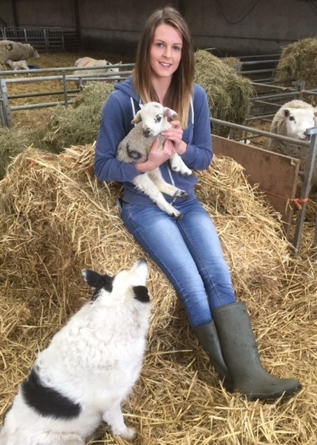 AMY Hough with a newborn lamb at her father's farm