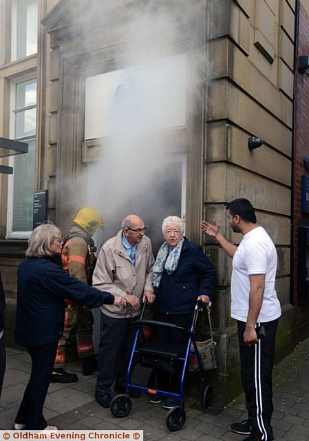 SHOCKED customers leave the bank following the incident