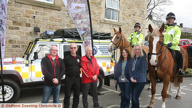 SHOWCASE . . . from left, Saddleworth parish councillor Jamie Curley, Dr Dave Taylor, David Knight, both from Oldham Mountain Rescue, Jane Soriente, Christine Wilson with PC Kate Guest on Bumble, and PC John Bradshaw on Tangle