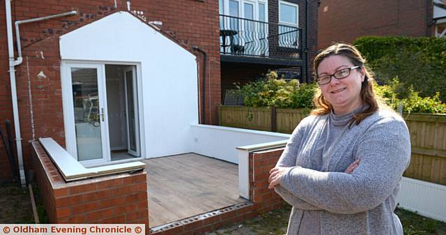 SO grateful . . . Amanda Dunne in the family's back garden where work has started for her son Matthew to play in