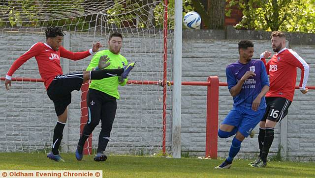 GET IT AWAY . . . Limeside's Wayne Ware clears the ball