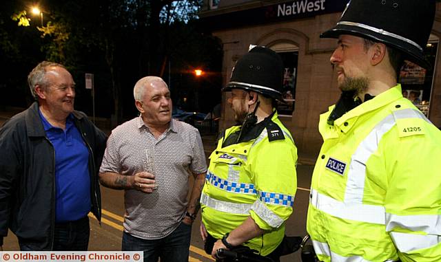 SATURDAY night out . . . David Rolands (left) and Clive Holt talking with Uppermill police officers S/Sgt Kris Curbley (left) and PC James Shillcock