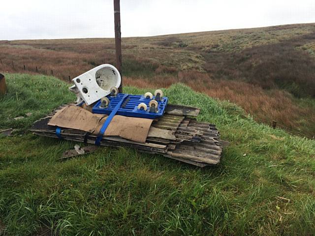 ASBESTOS corrugated roofing tied to a trolley and dumped along with a toilet