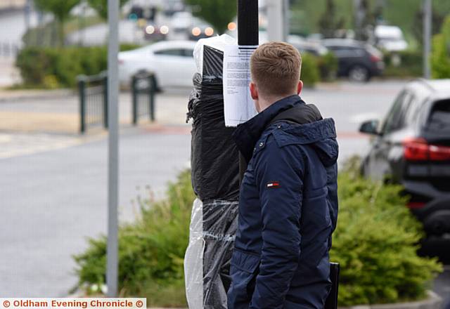 A driver reading the notice on meter.
