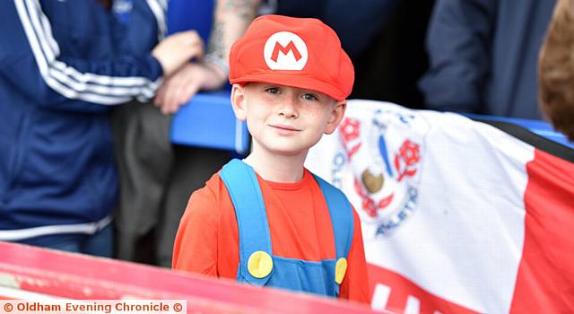 LOOKING cute . . . a young Latics fan dressed as Super Mario cheers on his super team