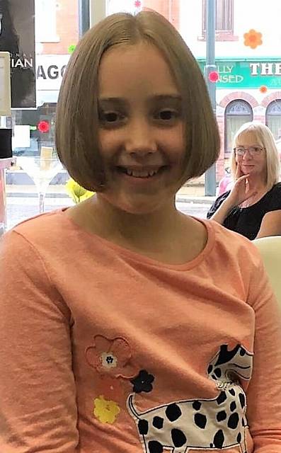 Emily Mahoney, of Trinity Brownies, Royton, had her hair cut for Little Princess Trust