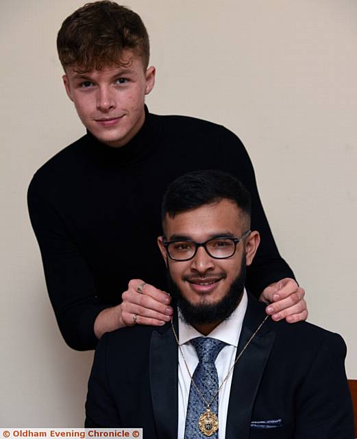 NEW mayor . . . Outgoing Youth Mayor T Jay Turner hands over the chain of office to new Mayor Marouf Ahmed