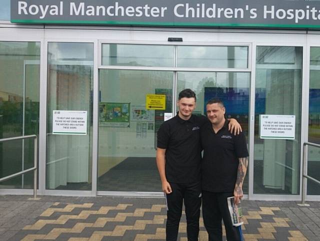 Paul Waterhouse (right with son Brandon Mason) visiting Manchester Children's Hospital to hand out get well soon cards and donations raised during Manchester Bee tattoo fundraiser at Paul's studio Forever-Inked