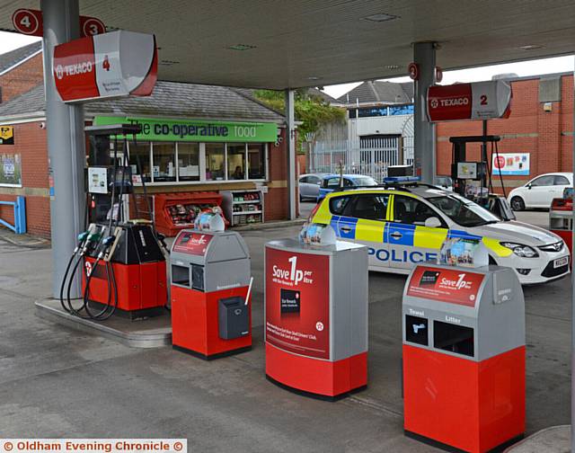 SCENE of robbery . . . Police at the Co-Op filling station at Lees