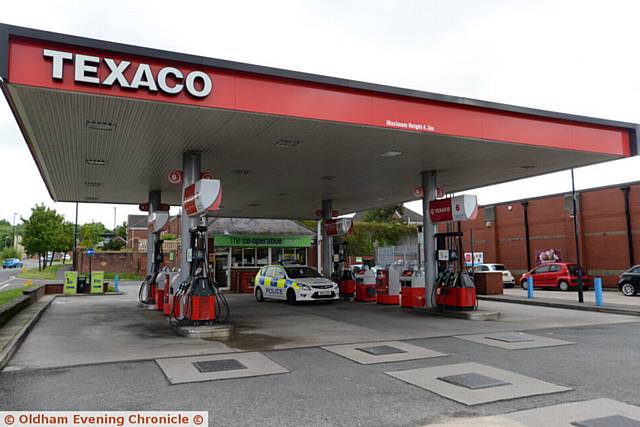 SCENE of robbery . . . Police at the Co-Op filling station at Lees