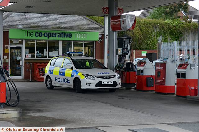 SCENE of robbery . . . Police at the Co-Op filling station at Lees