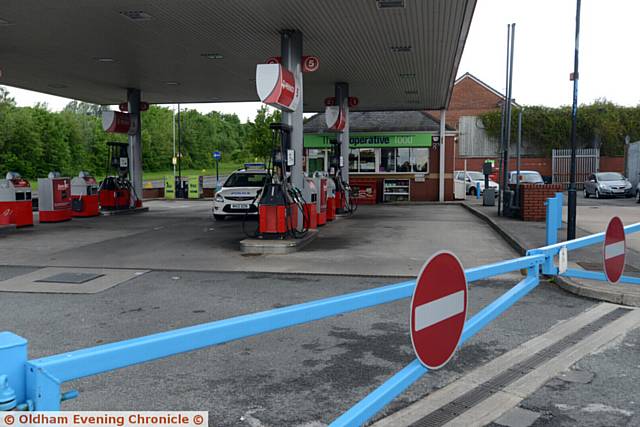 SCENE of robbery . . . Police at the Co-Op filling station at Lees