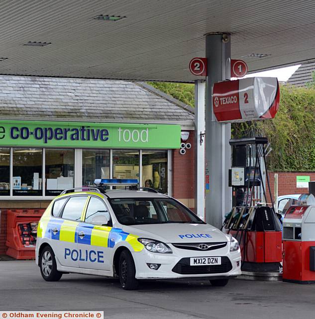 SCENE of robbery . . . Police at the Co-Op filling station at Lees