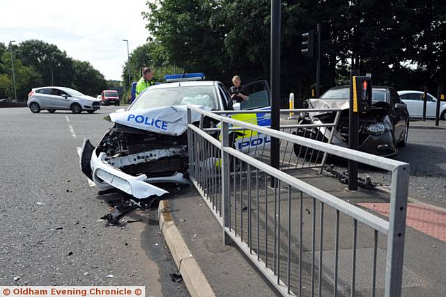 Police car involved in a collision with another car at the junction of Lees Road and Cross Street, Oldham.