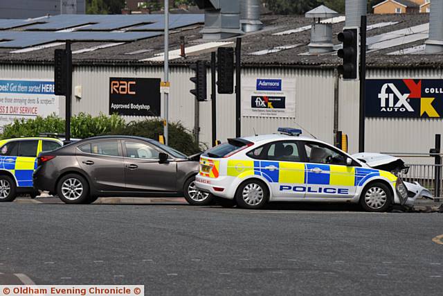 Police car involved in a collision with another car at the junction of Lees Road and Cross Street, Oldham.