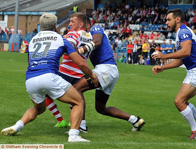 ON THE TURN: Oldham's Kenny Hughes is wrapped up by the Toulouse defence