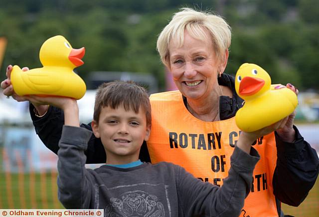 Saddleworth Show at Well-I-Hole Farm, Greenfield. Pictured here (l-r) Stevie Gregory (10) gets ready for the Rotary Club of Saddleworth duck race with Gill Bussey of Rotary Club of Saddleworth
