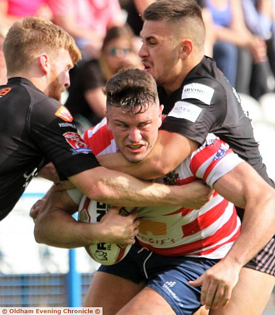 BATTLE STATIONS . . . Luke Adamson is grabbed
