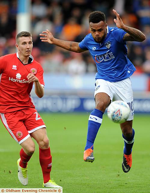 EYES ON THE BALL . . . Athletic front man Aaron Amadi-Holloway drives forward