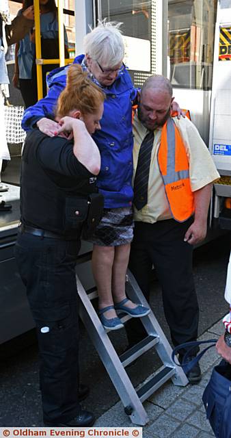 HELP . . . Passenger Vera Burn is given assistance getting off the tram