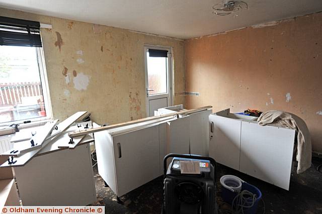 Neil Kelsall, who bought his rented flat from First Choice Homes wants them to help with repairs, after his home suffered water damage caused by a burst in the flat next door. Pic shows kitchen units after being moved into the living room.
